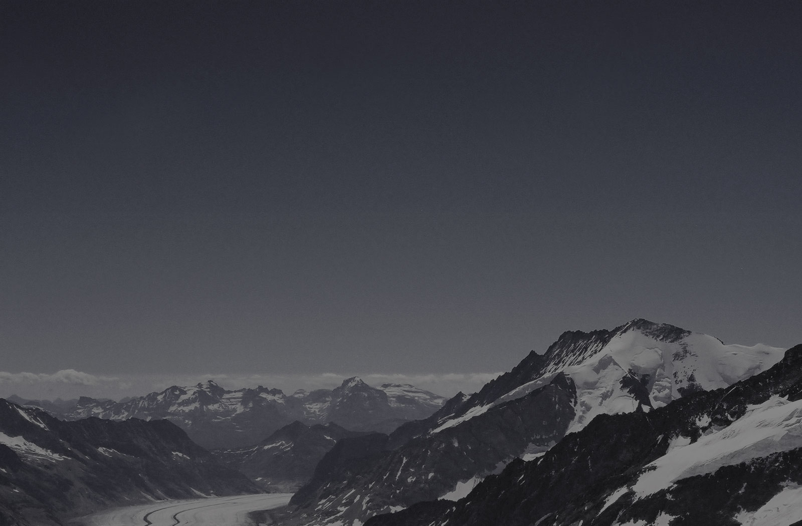 Snow Covered Valley Between Mountains at Jungfrau Summit, Switzerland - travel lifestyle blog