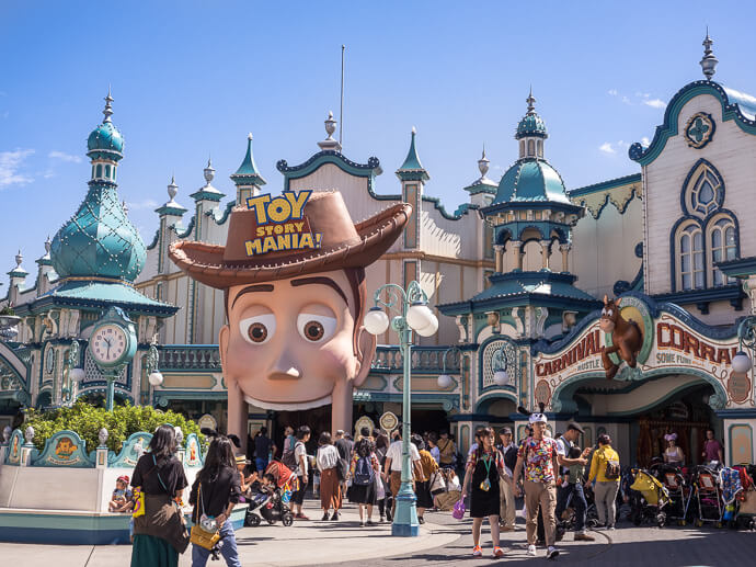 Image of Toy Story Mania attraction during the day with people walking past