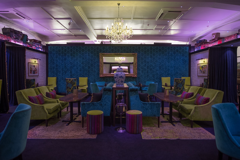 The velvet lime green and blue dining room or lounge area in Emporium Eatery one of the best places to eat in Napier