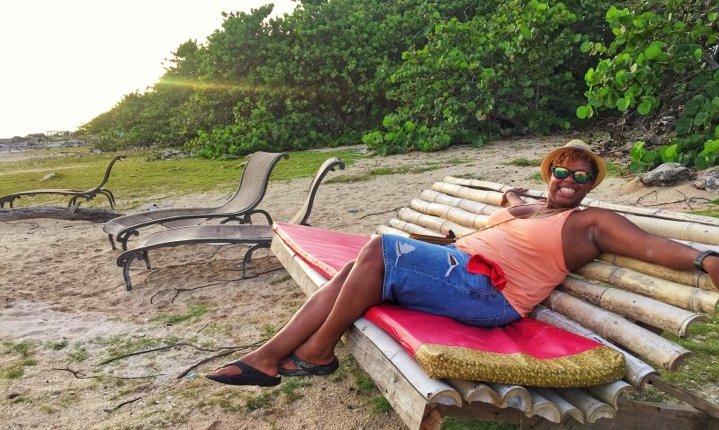Vonita of Soul in Love With Travel sitting on a chair at the beach